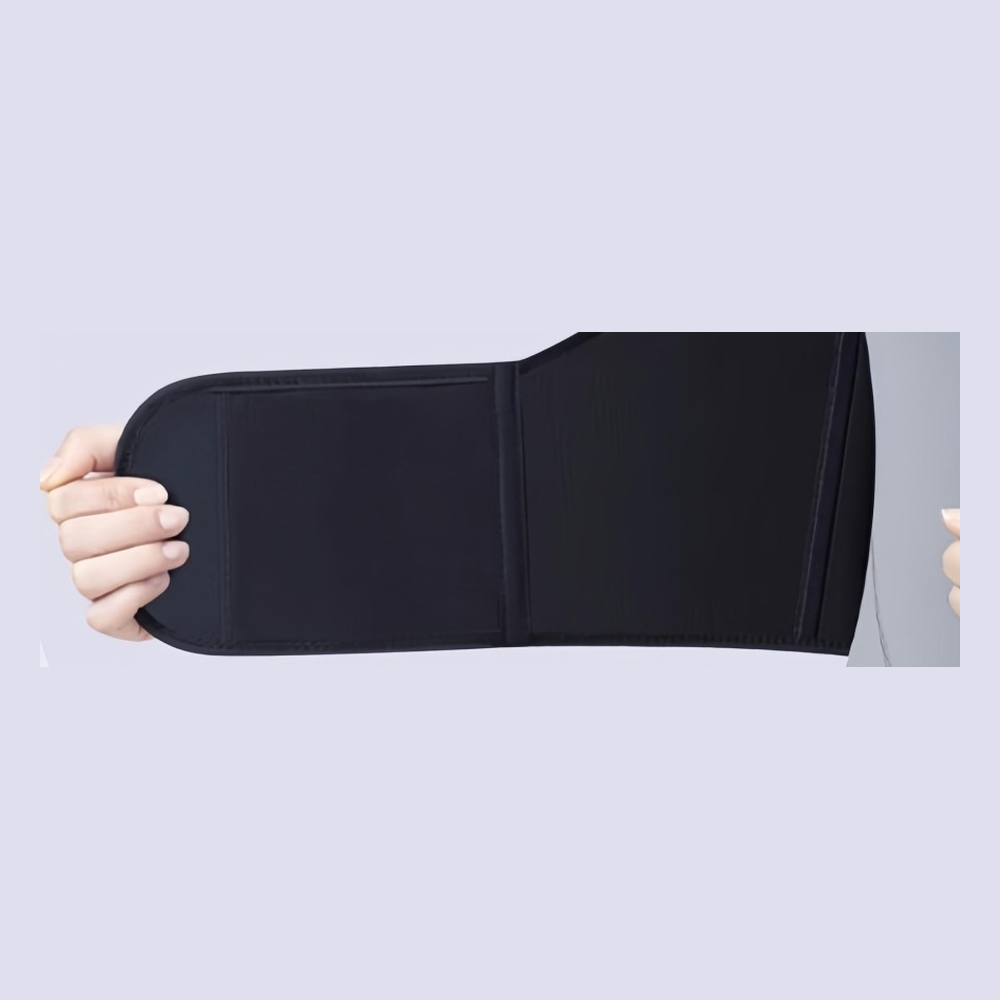 Close-up of the adjustable hook-and-loop waist band being opened by hand